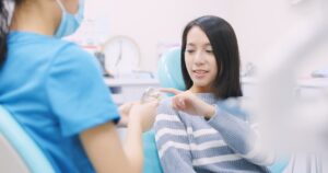 Doctor dentist explain the implant of teeth to patient in dental clinic